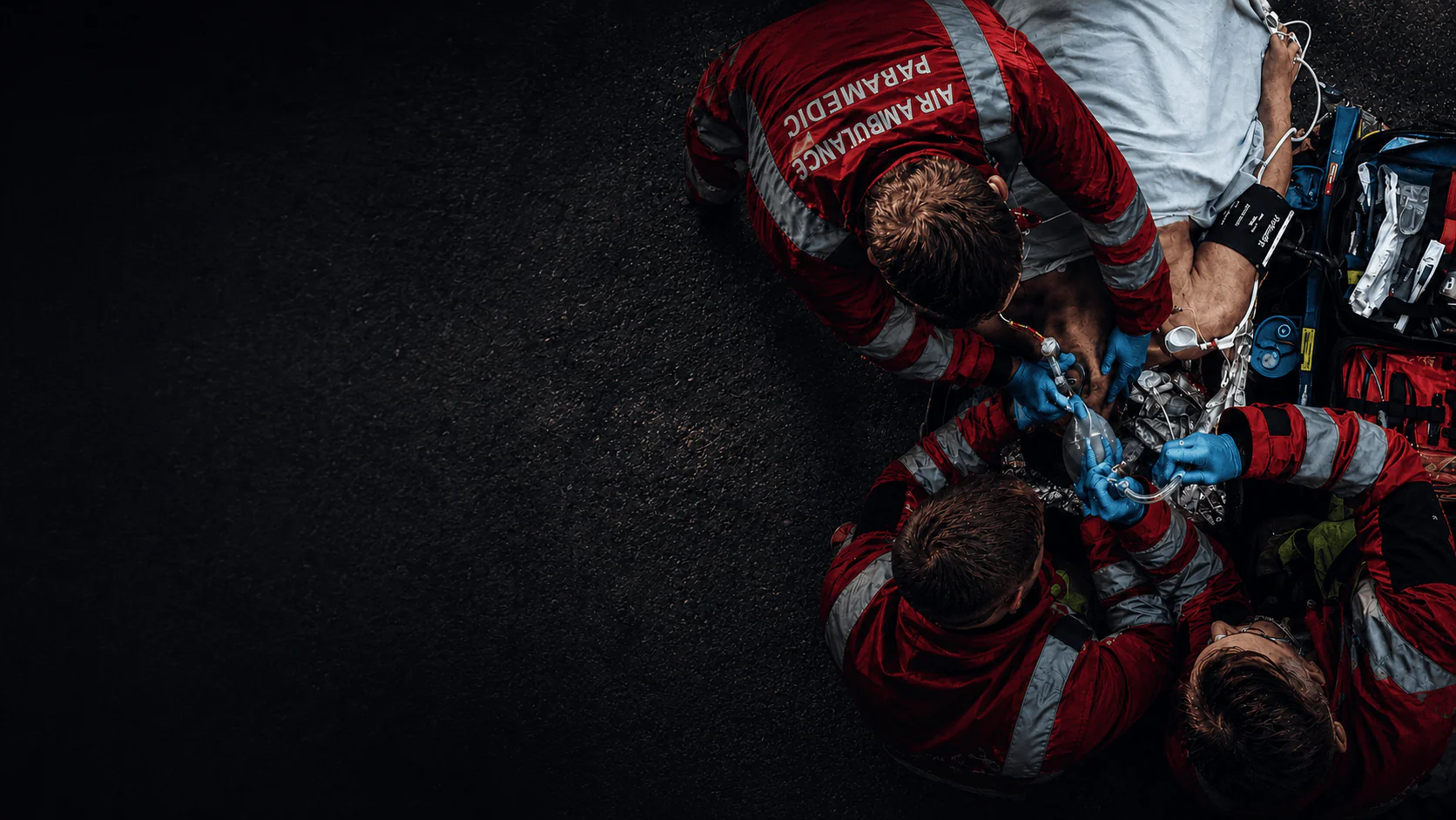 Air ambulance paramedics working around a patient during an airway emergency